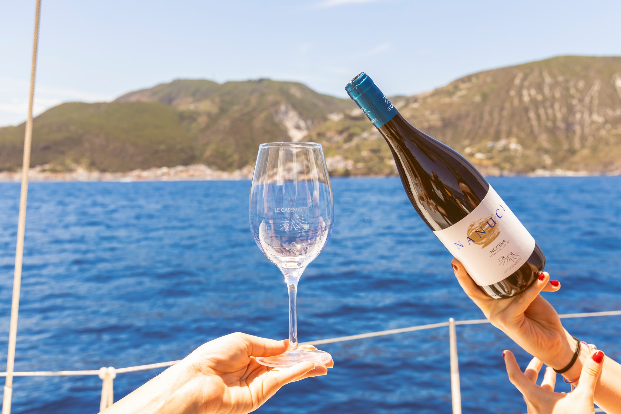 Image Of Someone Pouring Le Casematte Wine On A Boat Image of someone pouring le casematte wine on a boat